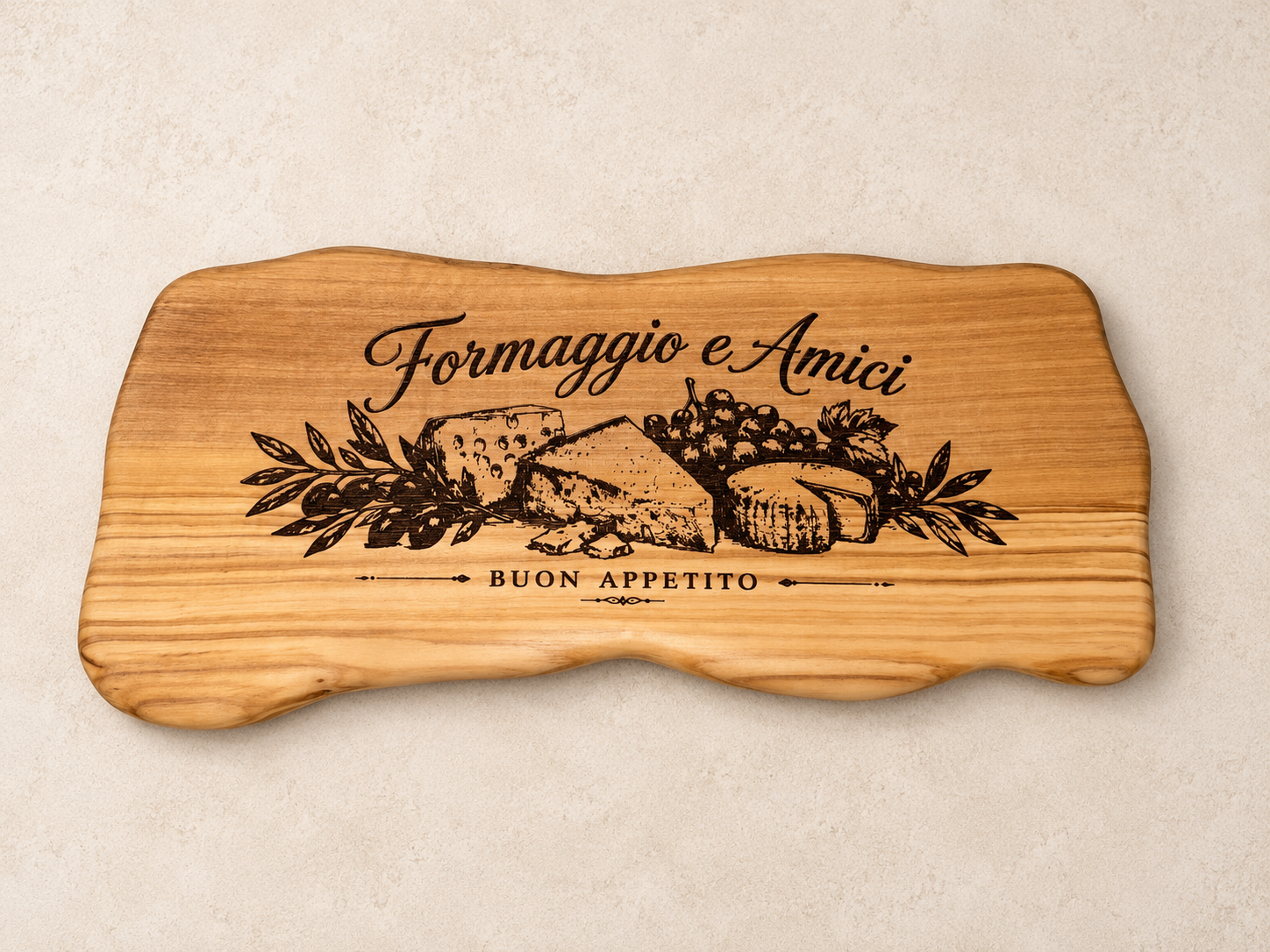 Our olive wood board with Formaggio e Amici lettering and a detailed laser-engraved illustration of cheese, grapes, and leaves